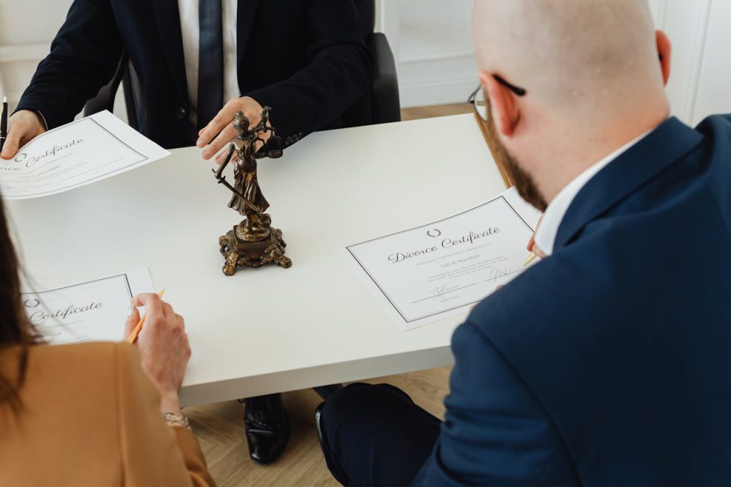 pexels photo 7876040 A professional setting with a focus on signing divorce documents in an office environment.